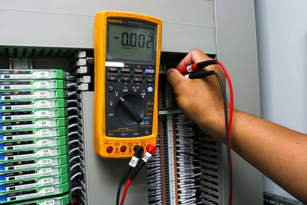 voltage meter being used on an industrial fuse board