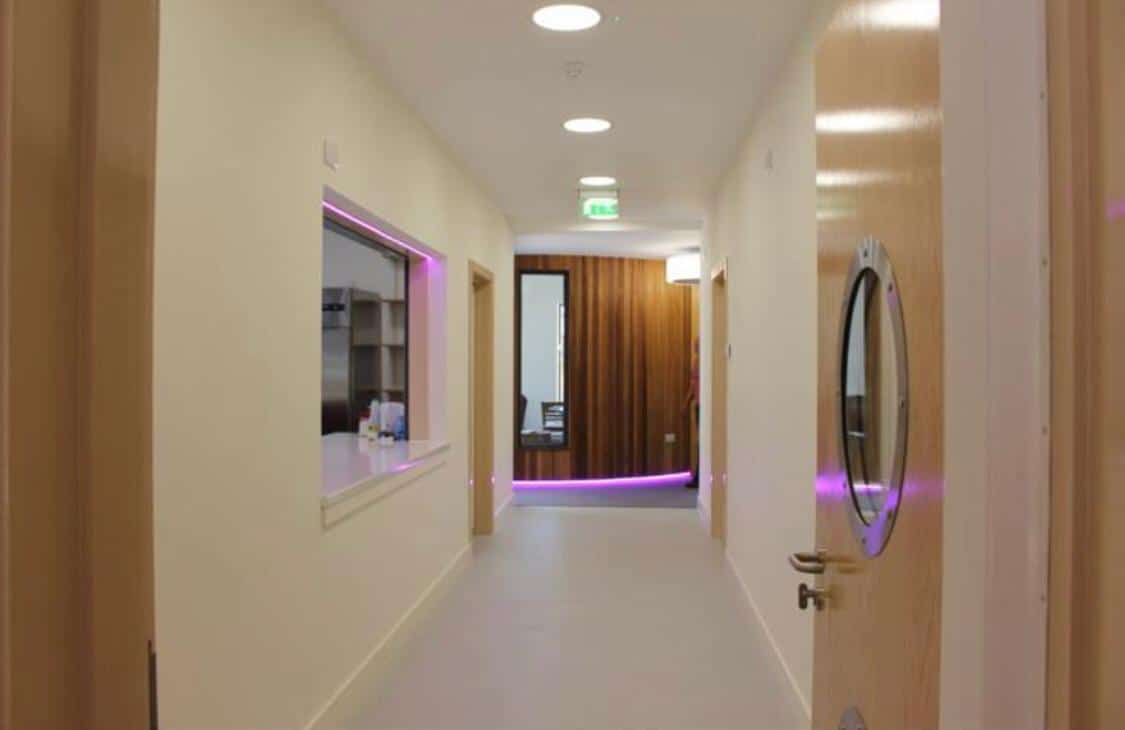 Beige coloured hallway with Purple strip lights