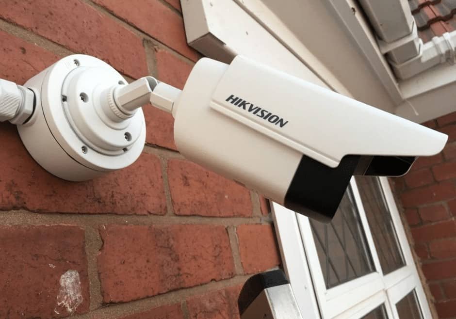 White Hivision camera installed on a home property